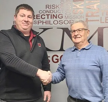 Two men shaking hands in the KME Accounting office